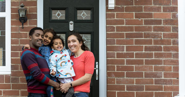 Family stood outside home - stock